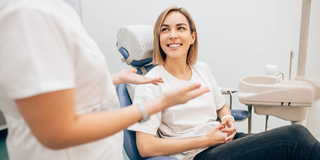 female dental patient after dental procedure smiling
