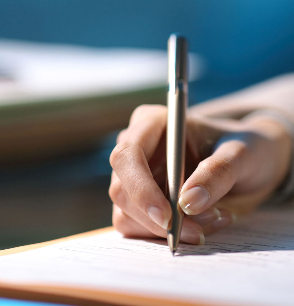 person with pen and documents