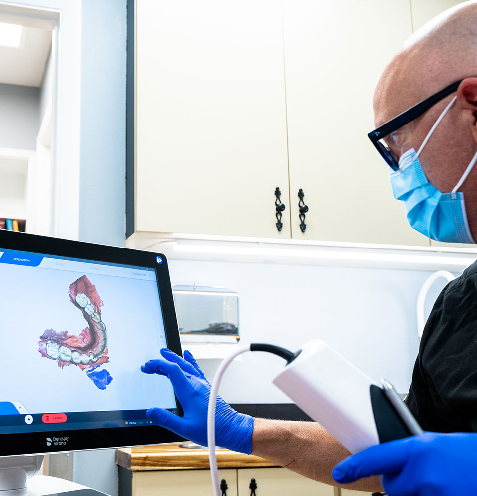 Dr. R. Benjamin Scott looking at 3d scan of teeth