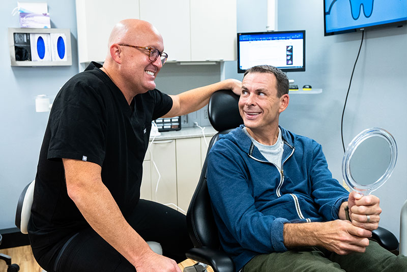 Dr. R. Benjamin Scott and patient going over results of gum disease treatment