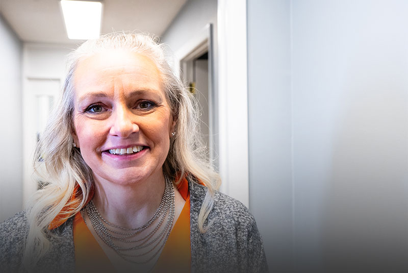 patient smiling after getting lower implants
