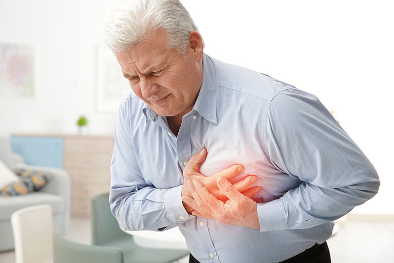 man holding chest in pain